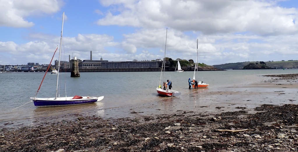 Sailing dinghies at anchor near a beach